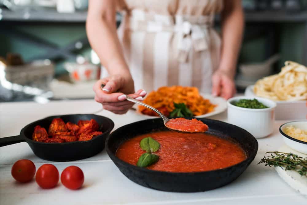 Woman making homemade tomato sauce