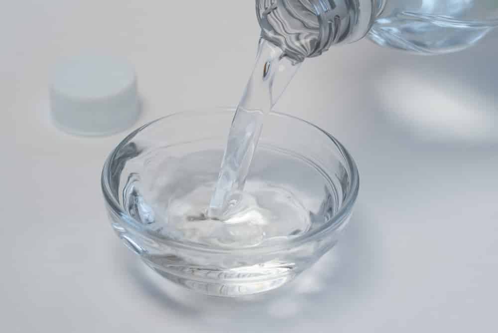 Pouring White Vinegar into an Ingredient Bowl