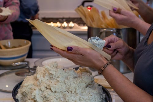 Spreading masa on corn husks