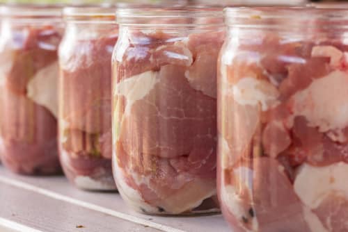 Put raw meat inside the jars