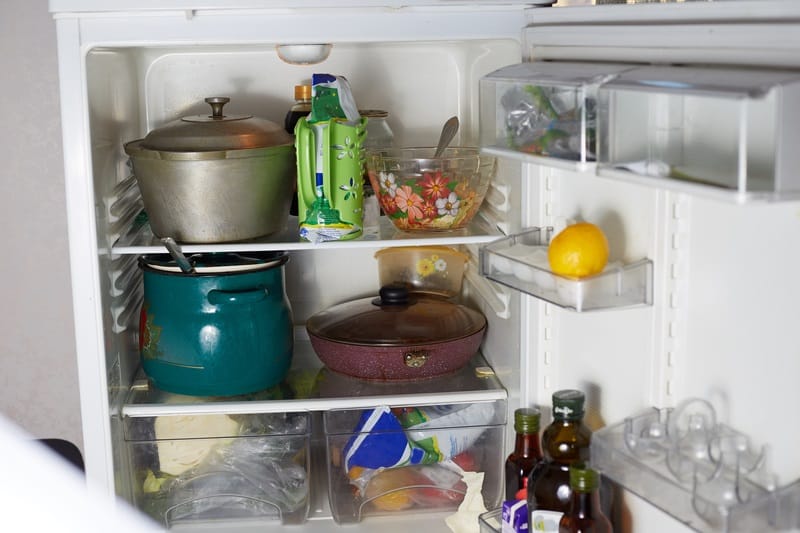 old refrigerator with dirty dishes pots cups groceries