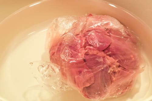 Submerge the bag-packed meat in cold water