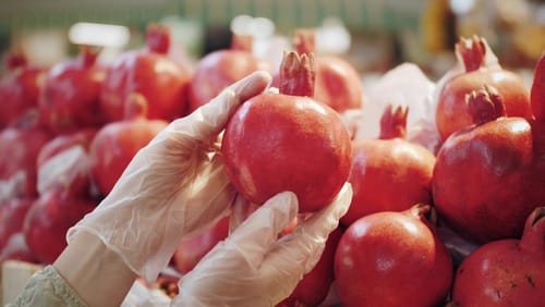 Picking Pomegranates at the Store