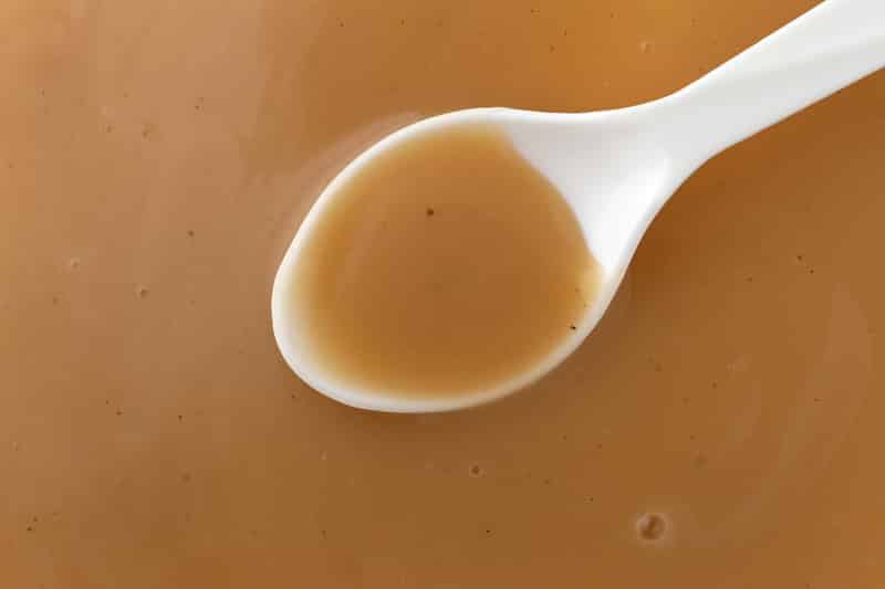 top view creamy brown turkey gravy white spoon