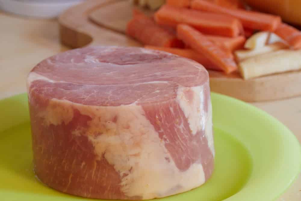 Gammon joint uncooked resting on a plate