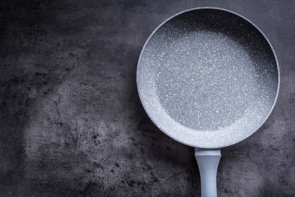 Ceramic pan on concrete kitchen board