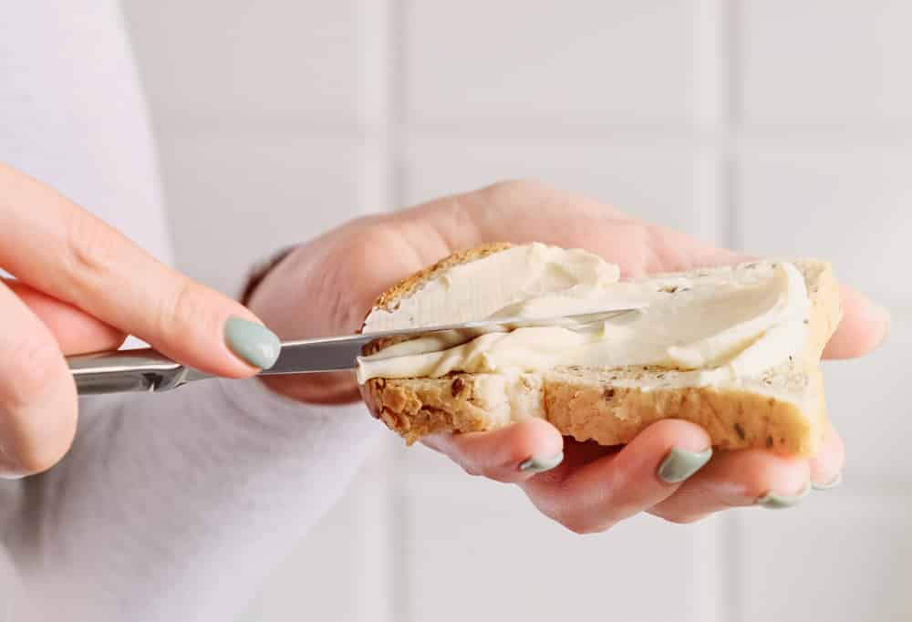 Female hands making a sandwich