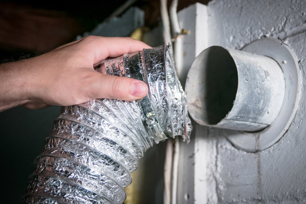 Flexible aluminum dryer vent hose removed for cleaning