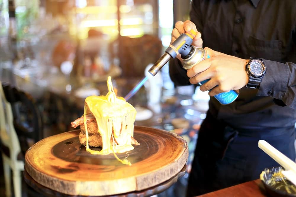 blow torch into the hot cheese