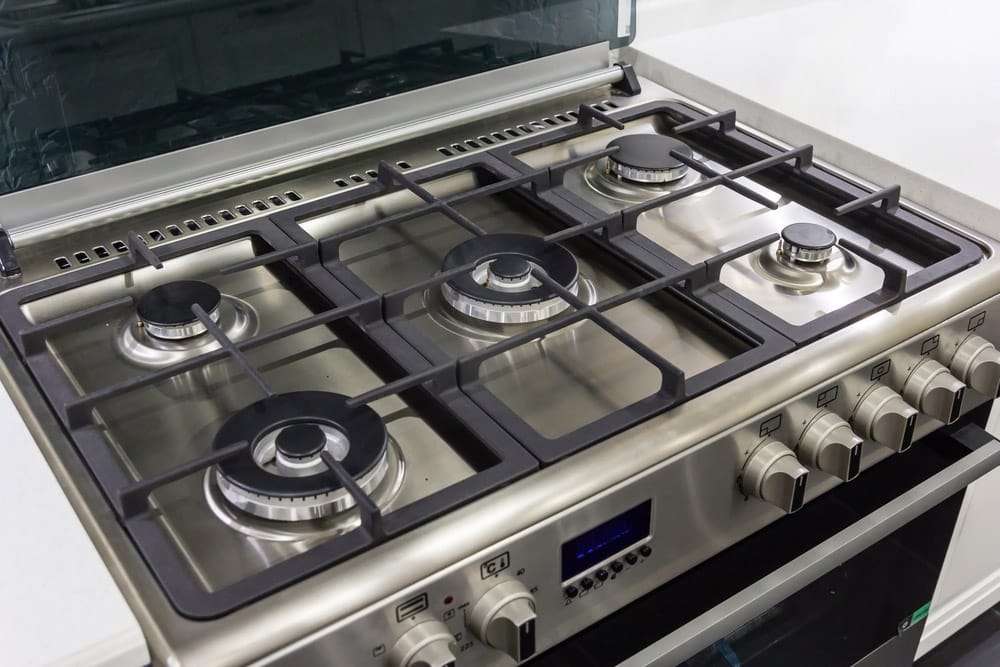 closeup of brand new, modern gas stove on countertop in modern home kitchen