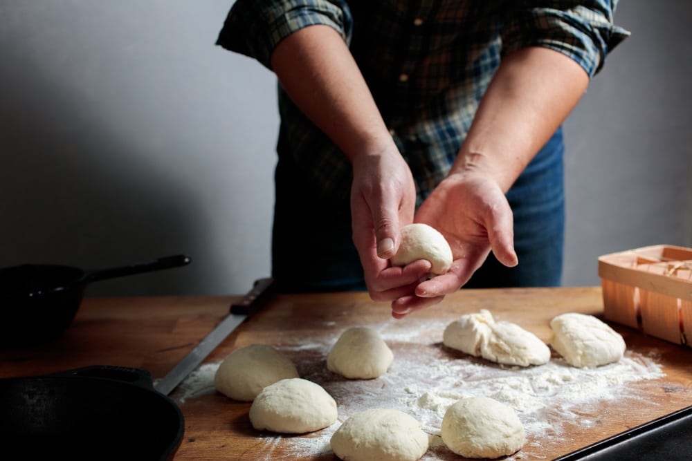 Man shaping dough into balls