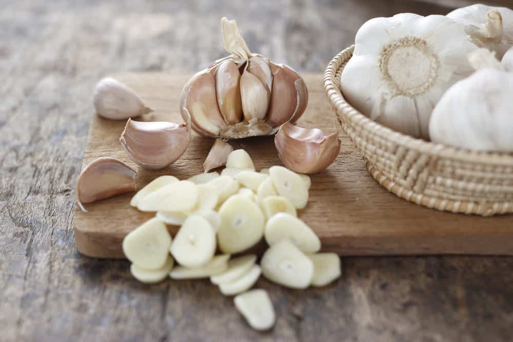 adding raw garlic to bread dough