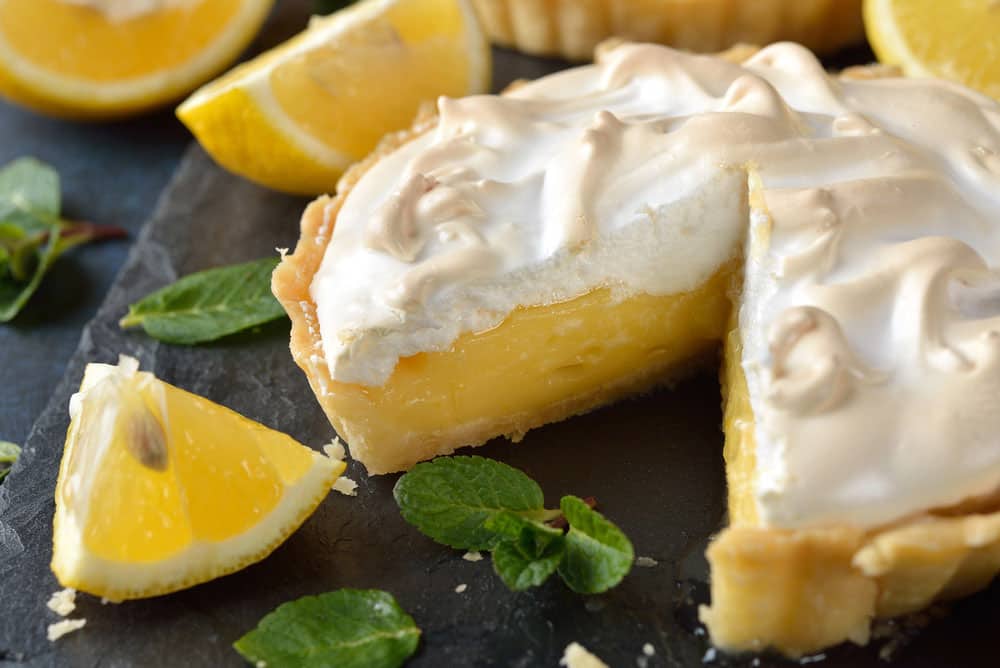 Lemon pie with meringue on a blue background