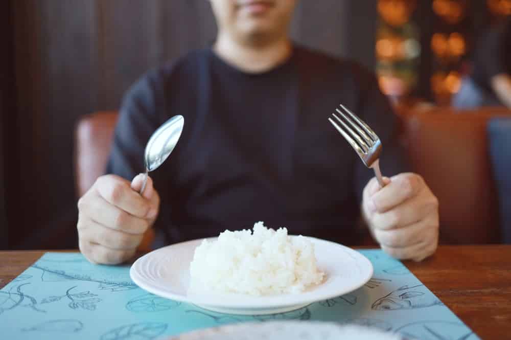 Man eating rice