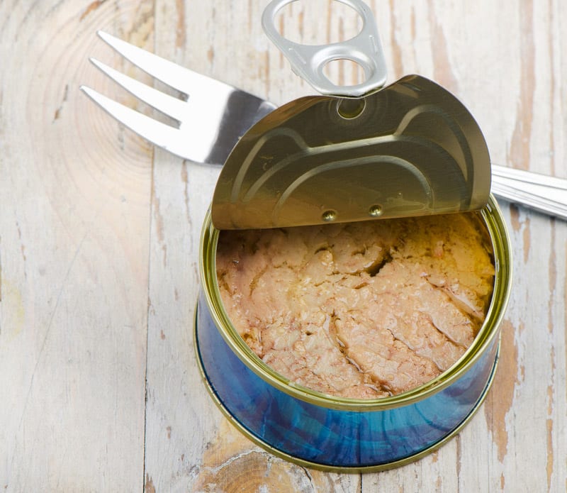 Canned tuna fish on wooden table