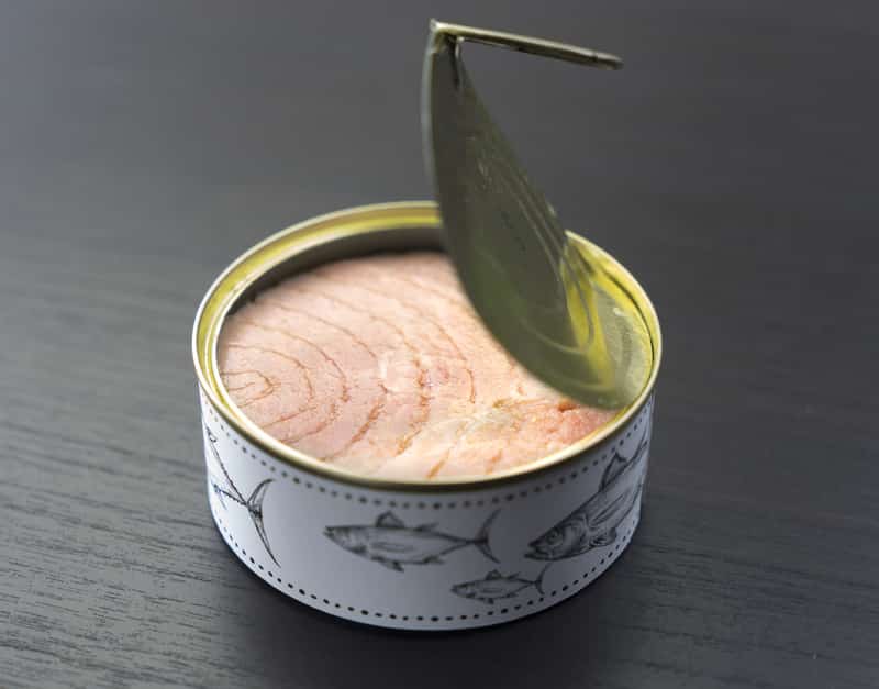 Fresh and soft canned tuna on the wooden table