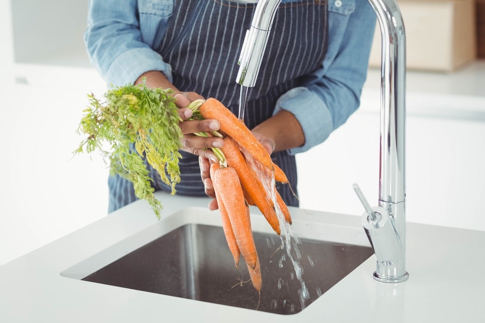 man washing carrots