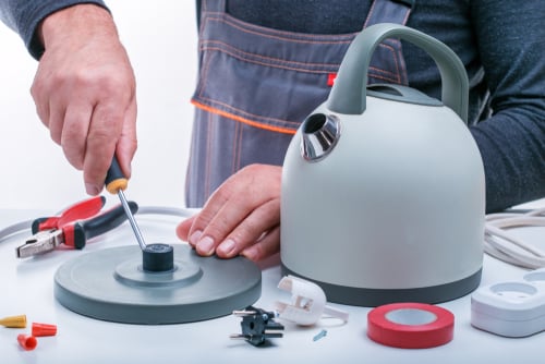 Technician repairs electric kettle