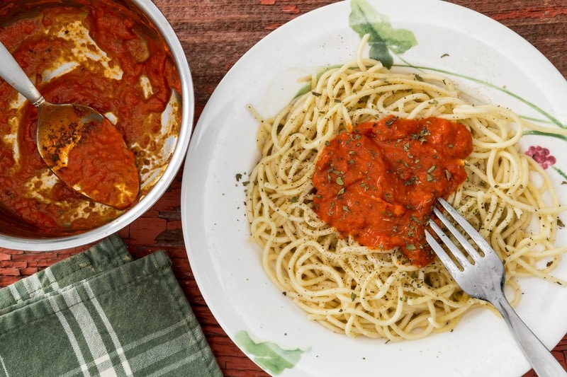 Preparing spaghetti pasta with sauce