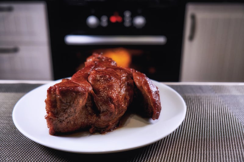 Big piece of meat on plate. Roast beef close-up.