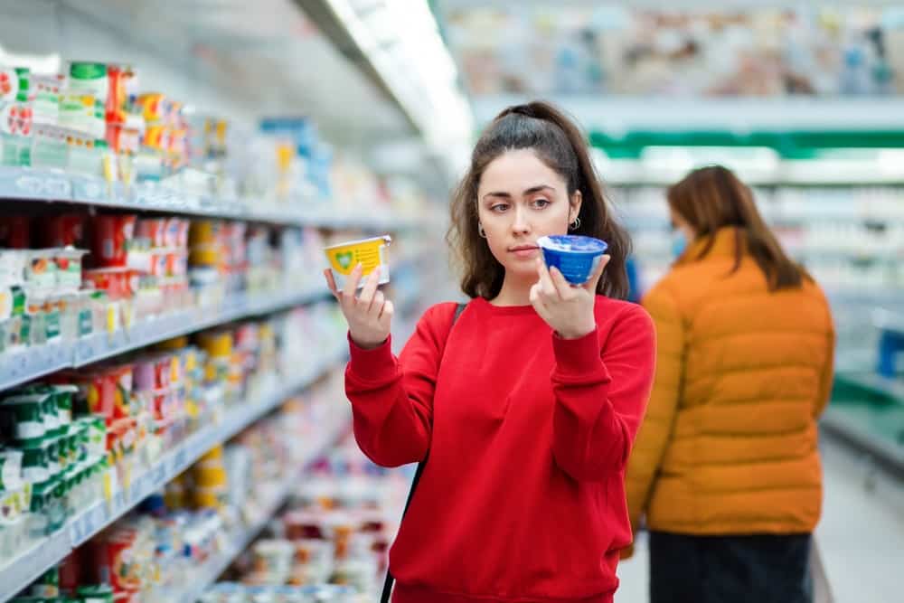 woman reading label yogurt