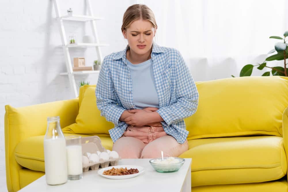 woman with allergy looking at food on table