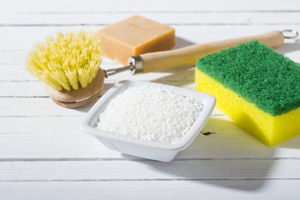 citric acid, cleaning brush, sponge and bar of soap