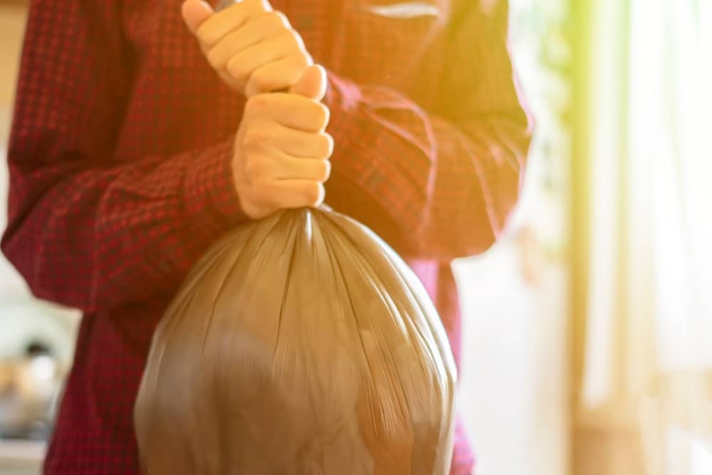 hand holding a trash garbage bag