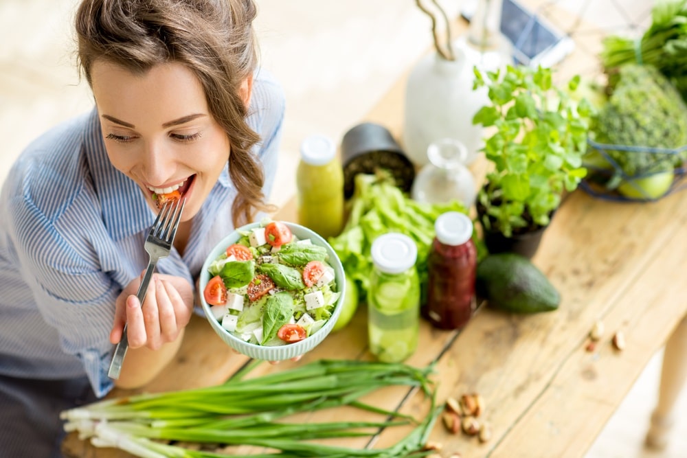 woman eating healthy salad green produce