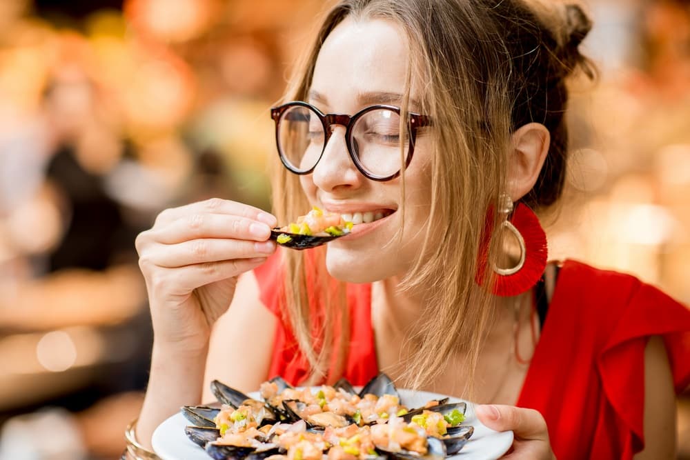 woman enjoying eating mussels