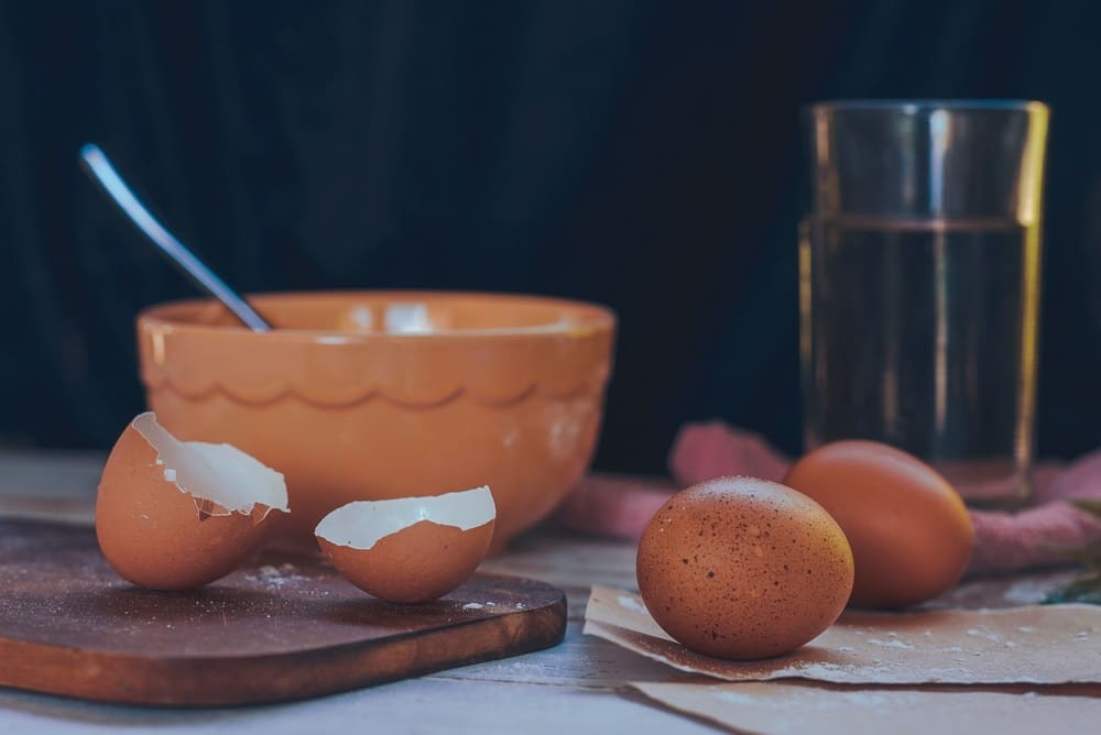 Chicken eggs placed near cups