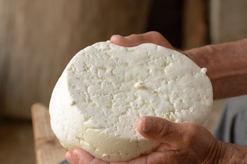 hands holding fresh queso fresco