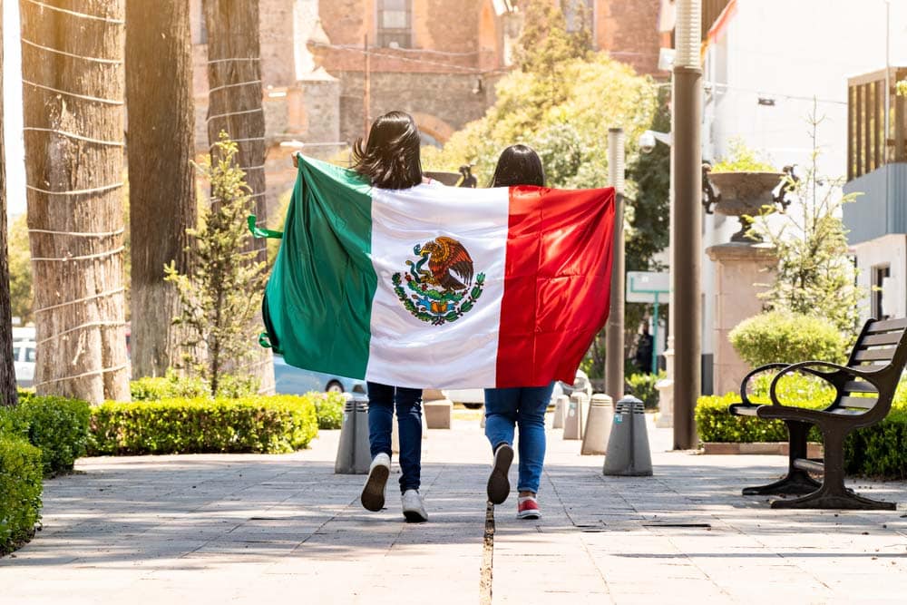 Two young women with mexican flag