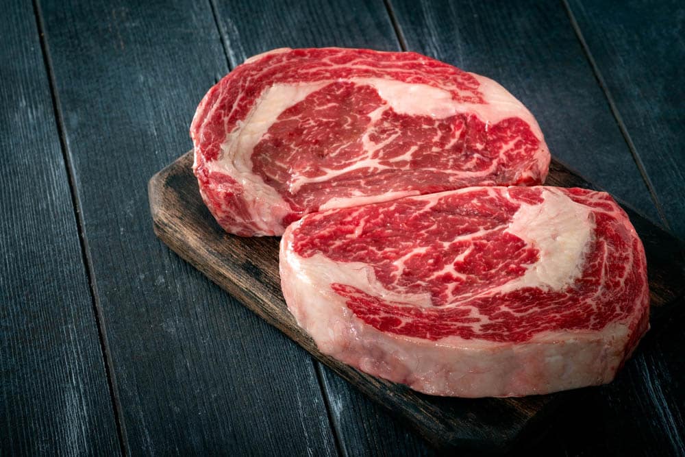 Raw rib eye beef steak