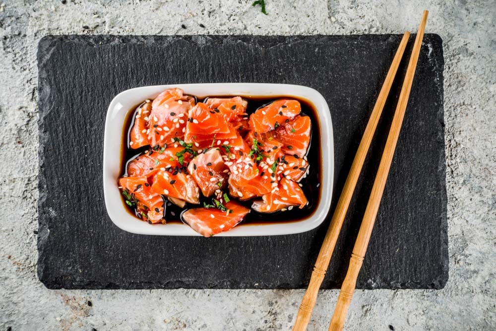 Salmon sashimi in marinade tamari