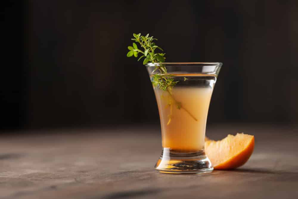 Alcoholic peach shot or liquor in a glass 