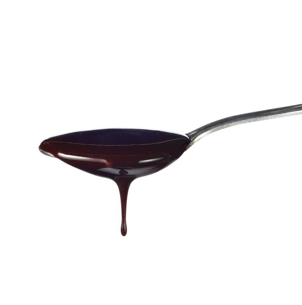 chocolate syrup leaking from spoon 