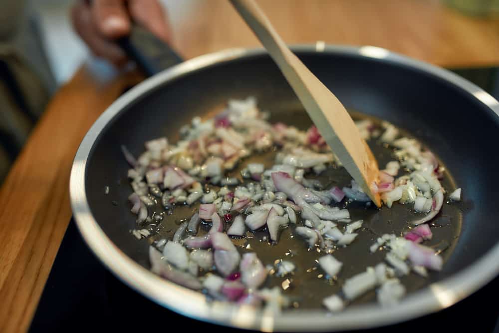 Close up of sauteed onion and garlic in the frying pan