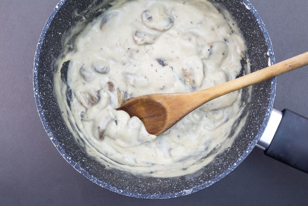 Creamy mushroom sauce close up in saucepan