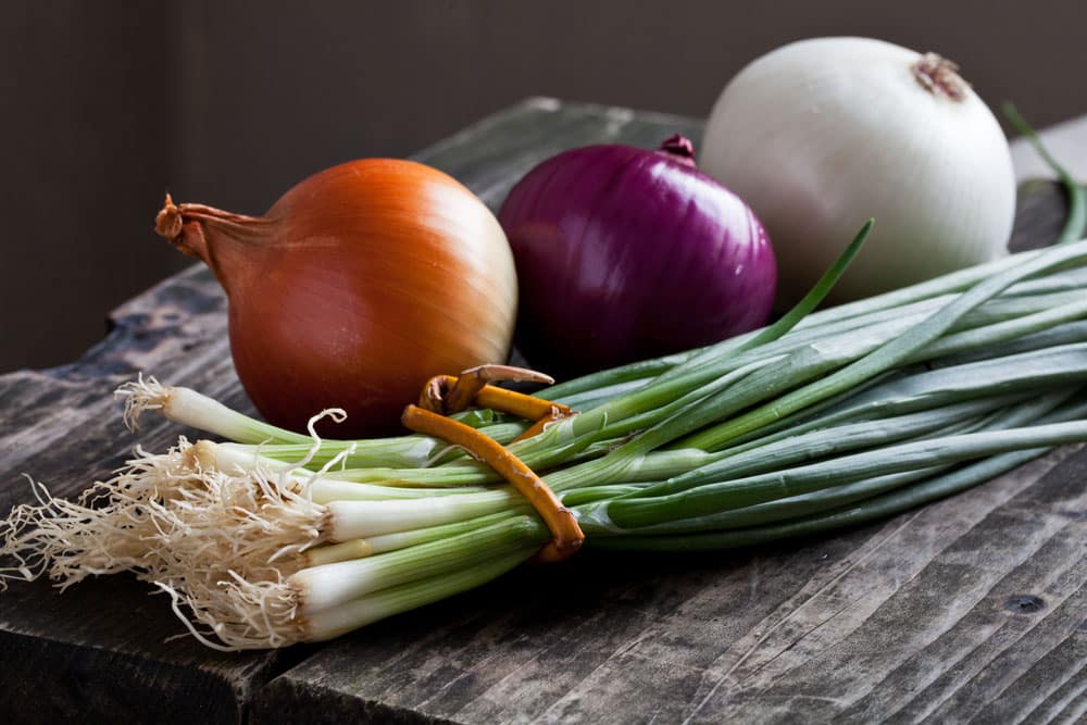 different onions on wood