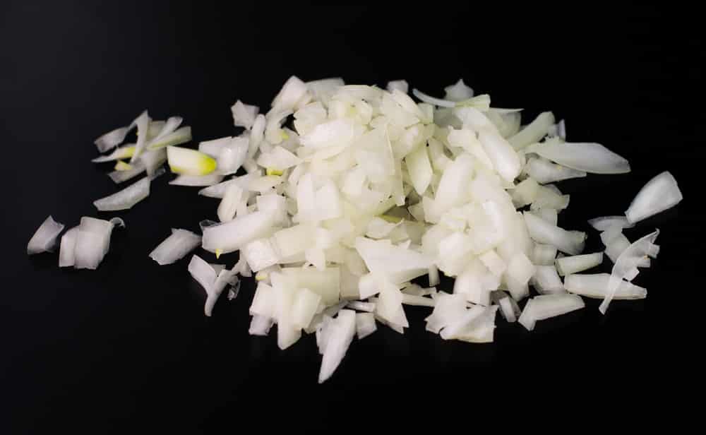 finely chopped onion on a dark surface