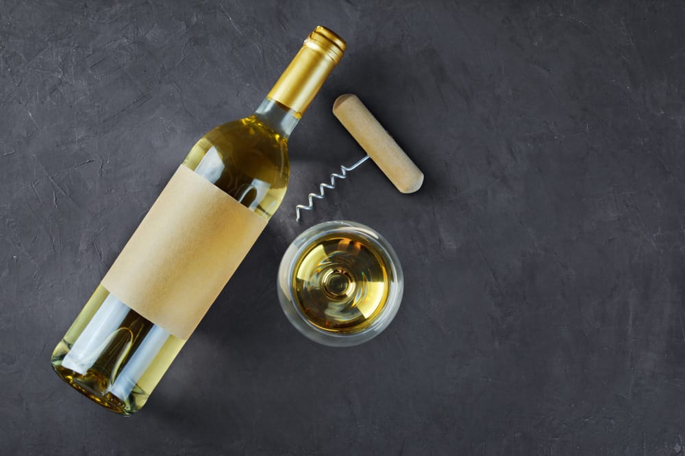 Flat lay of lying white wine bottle