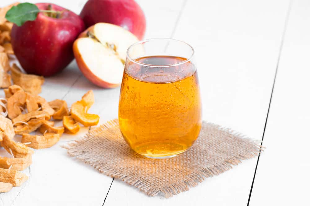 Fresh organic apple juice in glass cup