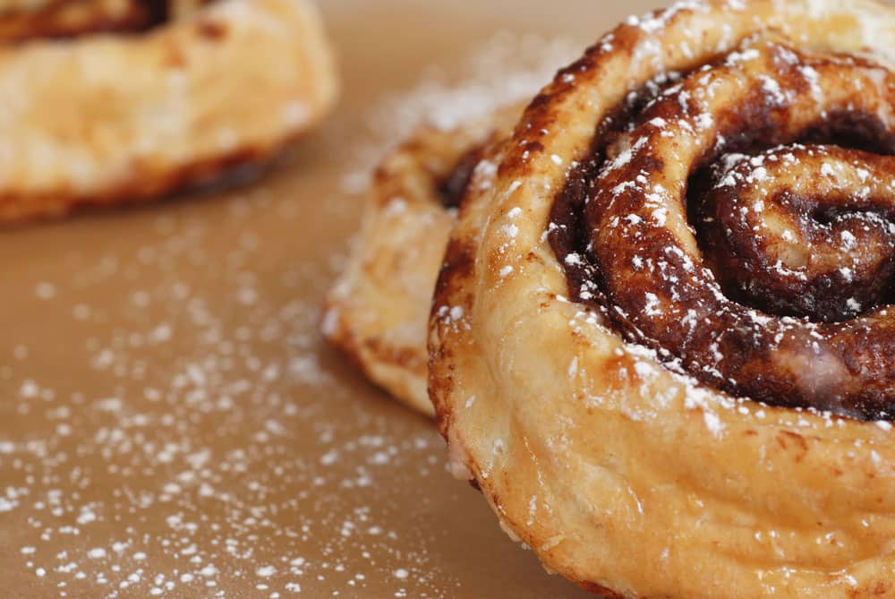 Freshly baked cinnamon rolls dusted with powdered sugar