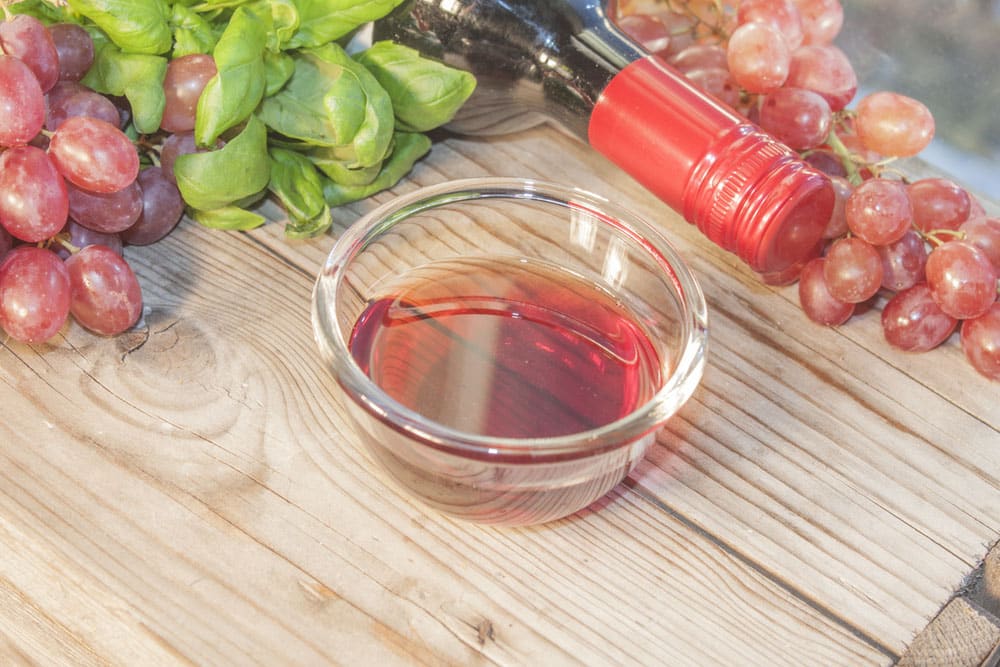 A glass bowl full of red wine vinegar