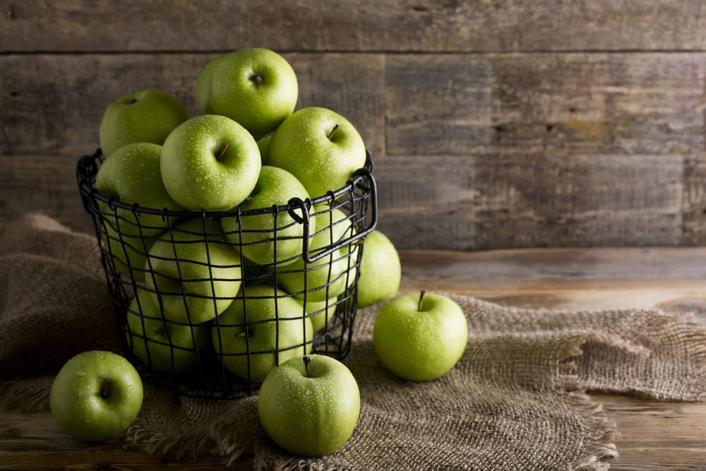 Green apples on a rustic table