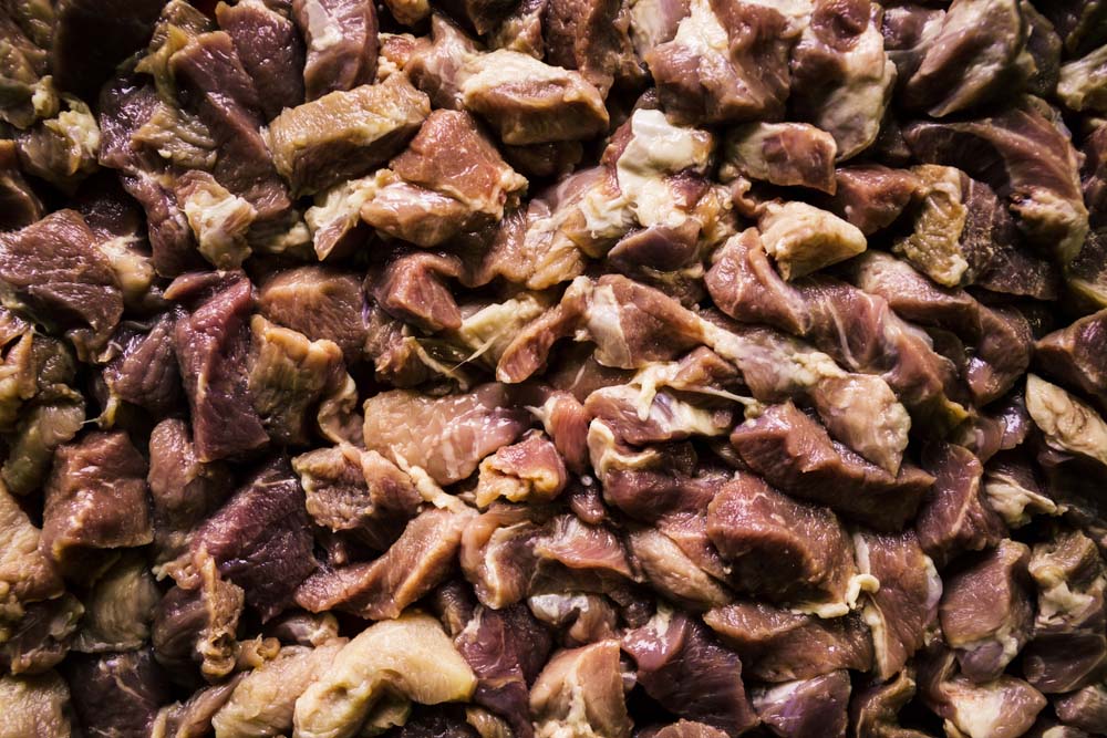 Heap of raw diced beef meat isolated
