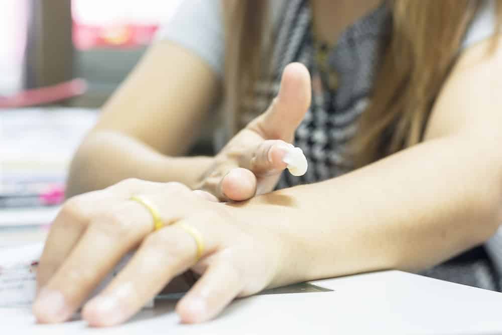 A long -haired woman's medicine on her arm