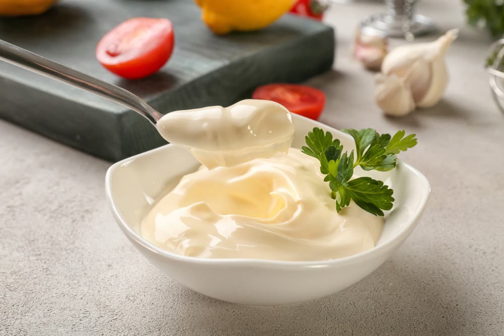 Mayonnaise in bowl and spoon