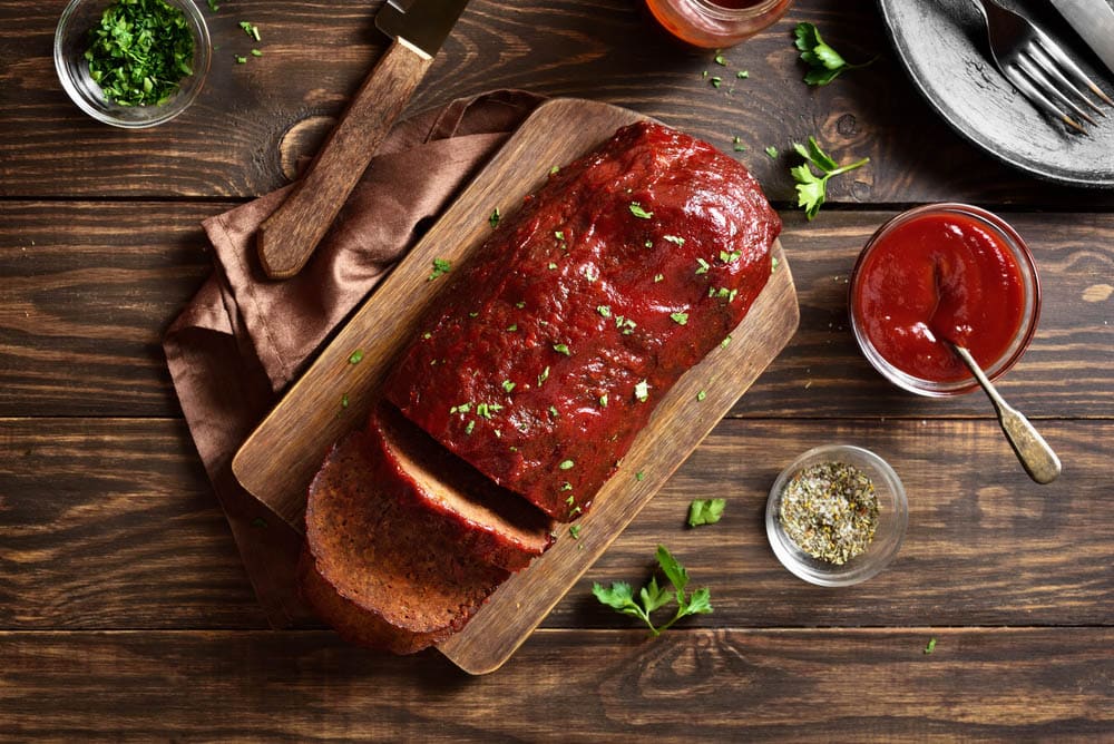 Meatloaf with glaze on cutting board